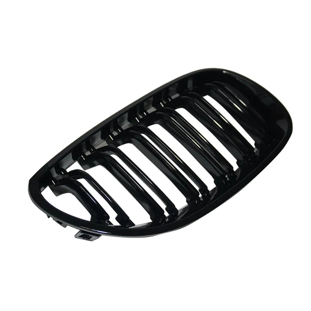 Pair of black carbon fibre pattern front grilles for a BMW 5-Series car.