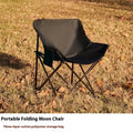 Beige folding camping chair with steel frame and Oxford cloth seat in outdoor setting