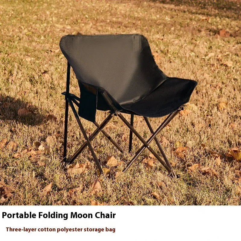 Beige folding camping chair with steel frame and Oxford cloth seat in outdoor setting