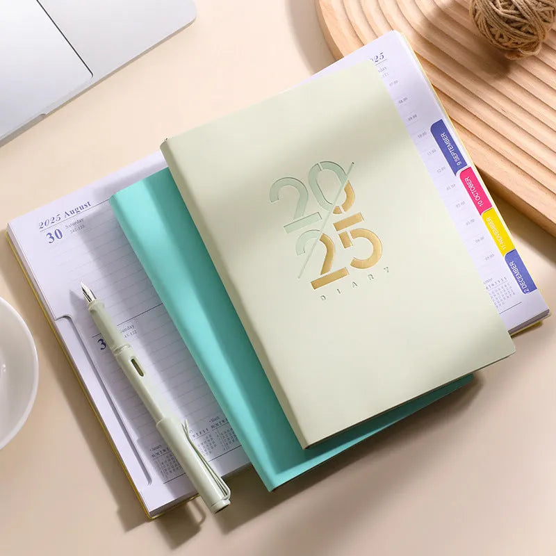 Soft cover A5 daily planner schedule book in blue, showing lay-flat binding and faux leather texture.