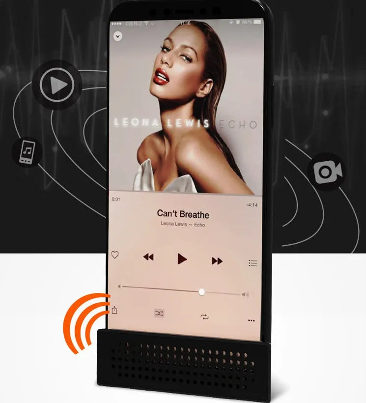 Mini black plastic phone amplifier bracket holding an Apple iPhone on a desktop