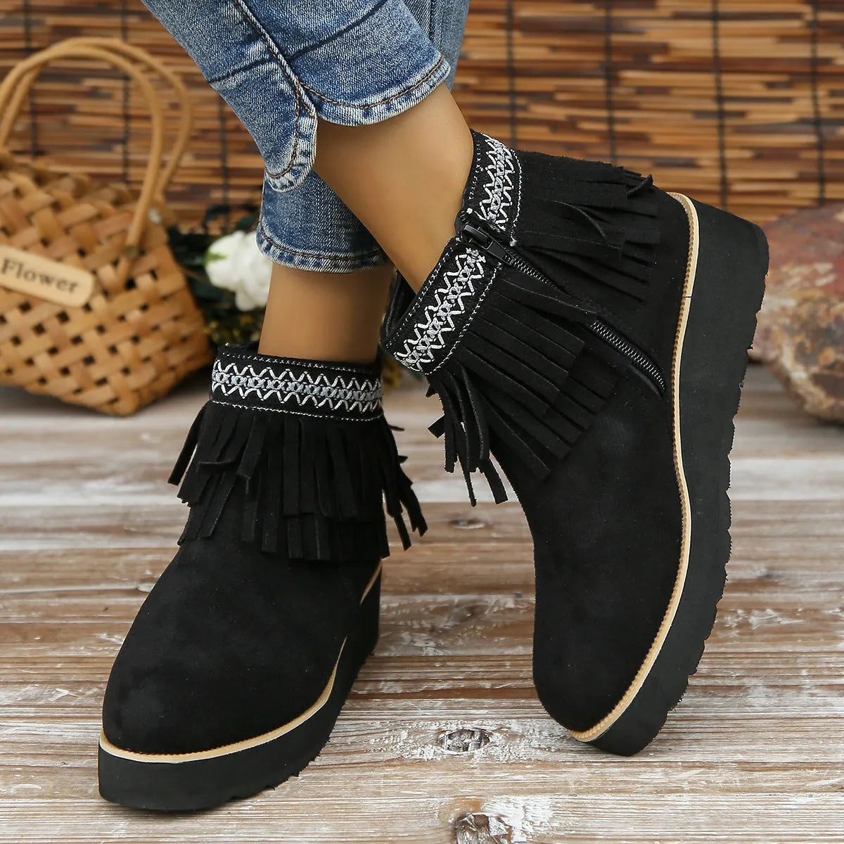 Women's dark brown suede wedge ankle boot with side zipper and tassel detail on a thick rubber sole.
