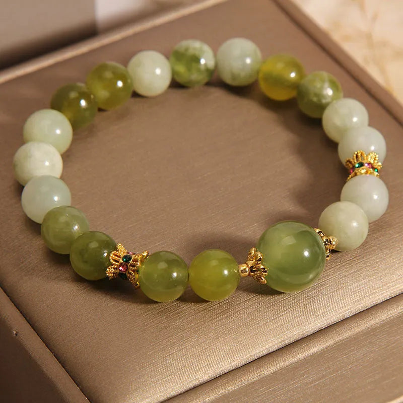 Original design women's bracelet with a single green Xiuyan jade stone in a Mori style.