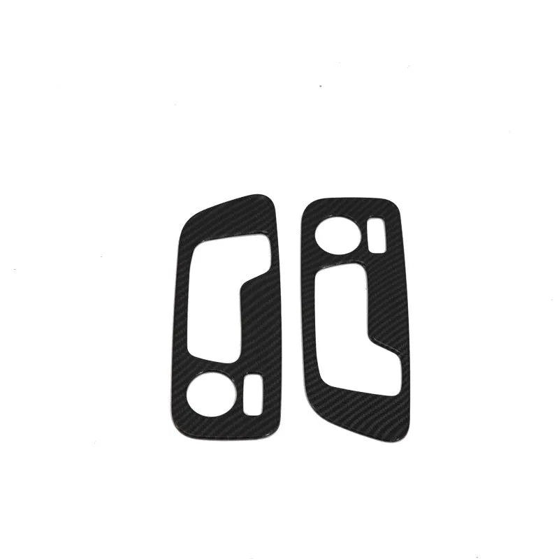 Matte black ABS plastic centre console trim panel for BMW X5 with cup holder and air vent controls.