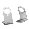 Silver portable magnetic bracket for iPhone 12, showing adjustable vertical stand on a desk.