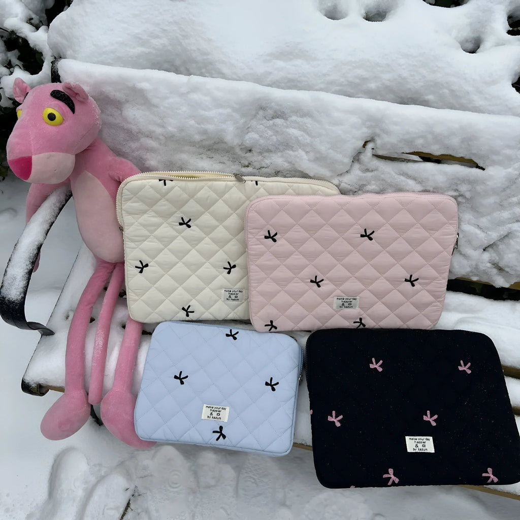 Cute rhombus embroidered bow laptop sleeve in light blue colour, zipper closure.