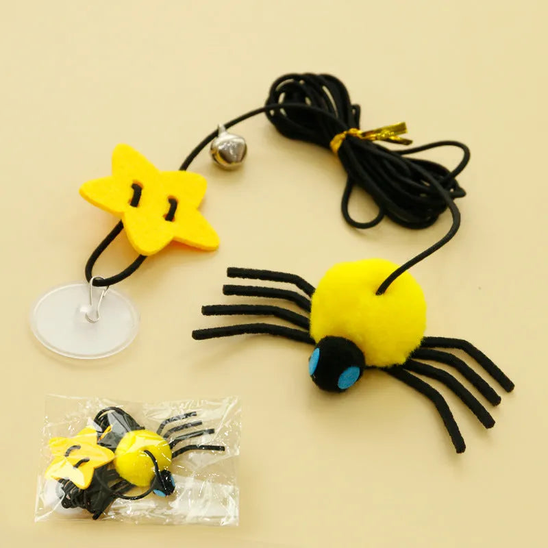 Hanging cat toy with red elastic rope, feather, and bell spider attachment mounted on door
