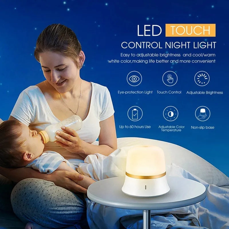 White cylindrical bedside night light with touch controls on a wooden surface.