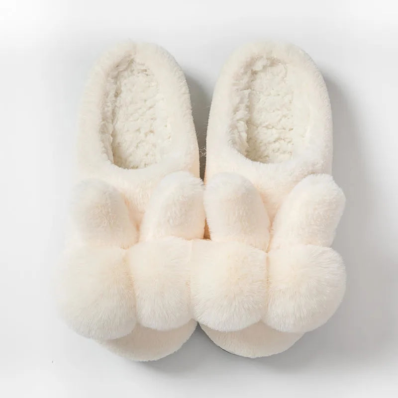 Women's rabbit fur slippers in grey with flower details and a high upper.