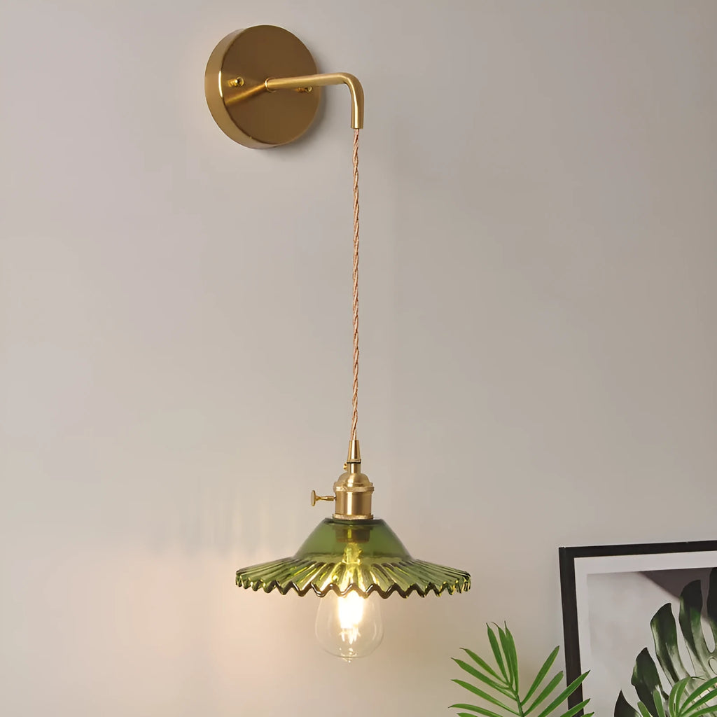 Brass lotus wall lamp with glass shade in six colour options on a wall
