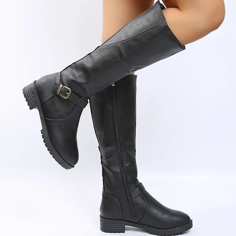 Women's black knight boots with a square heel, high shaft, and a front belt buckle fastening.