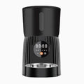 Black automatic pet feeder with digital display and food container on kitchen counter