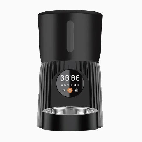 Black automatic pet feeder with digital display and food container on kitchen counter