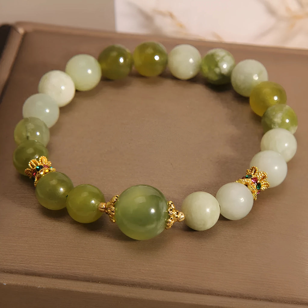 Original design women's bracelet with a single green Xiuyan jade stone in a Mori style.