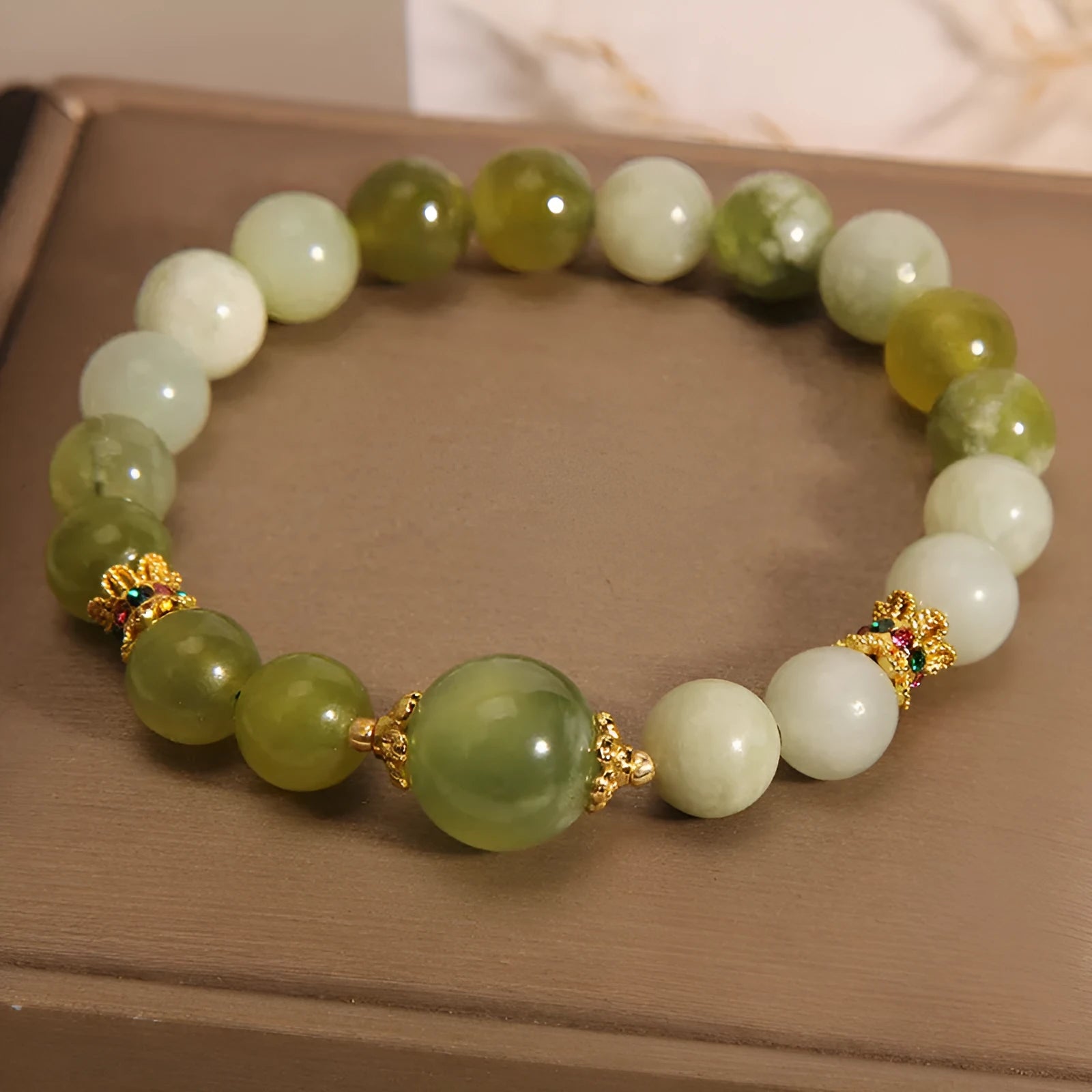 Original design women's bracelet with a single green Xiuyan jade stone in a Mori style.