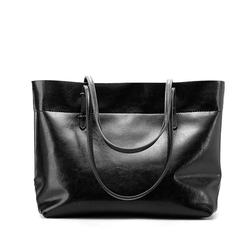 Brown leather crossbody handbag showing two main compartments and a front phone pouch