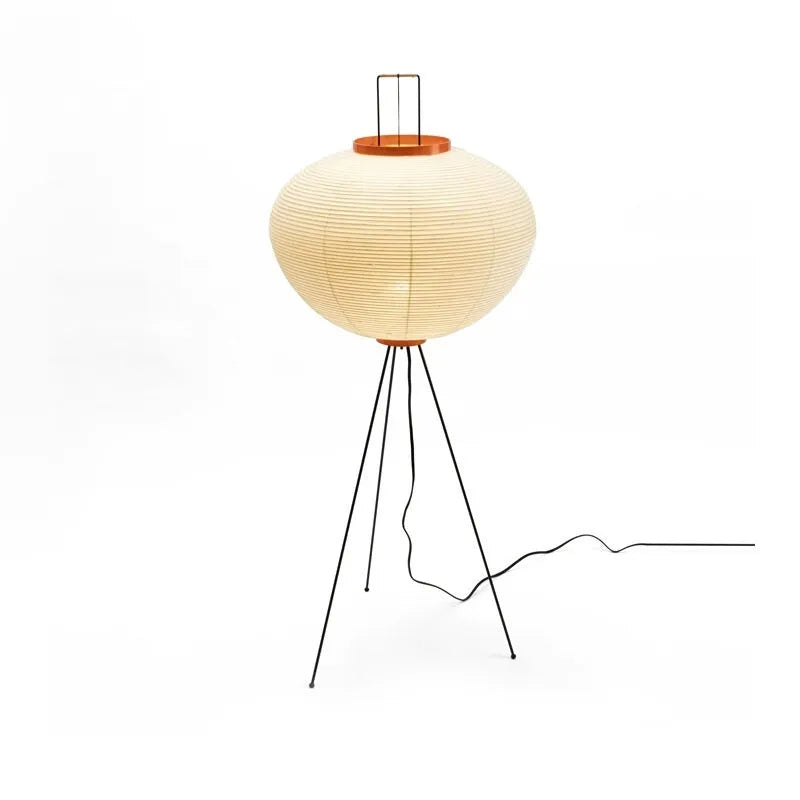 Japanese style handmade rice paper table lamp with an aluminium base on a wooden table.