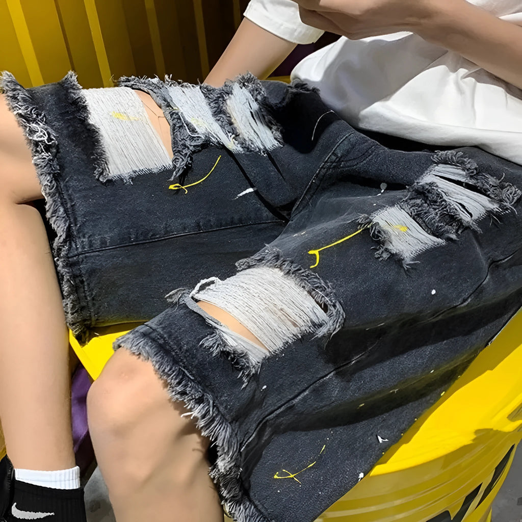 Men's loose-fit denim shorts with water-washed finish and distressed hole detailing in black colour