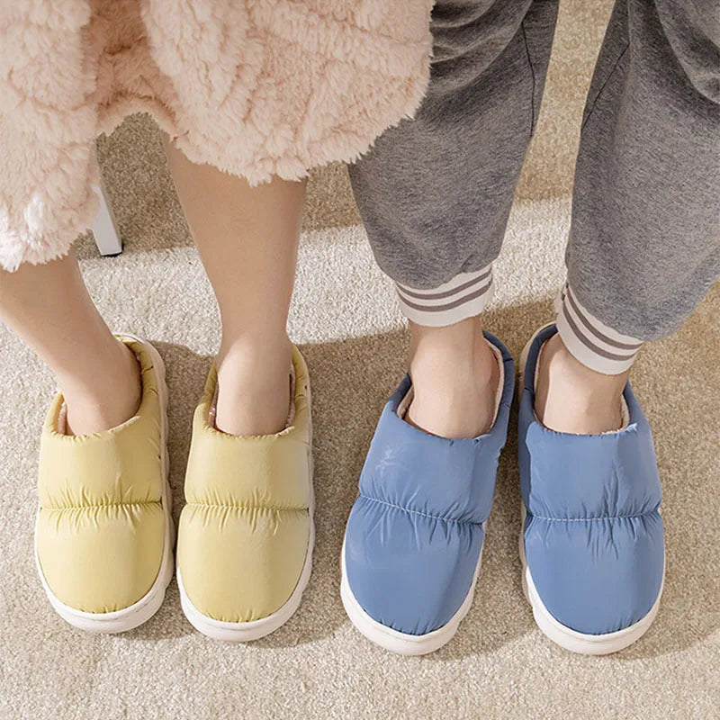 Blue winter slippers for indoor use with a thick rubber non-slip sole and artificial plush lining.