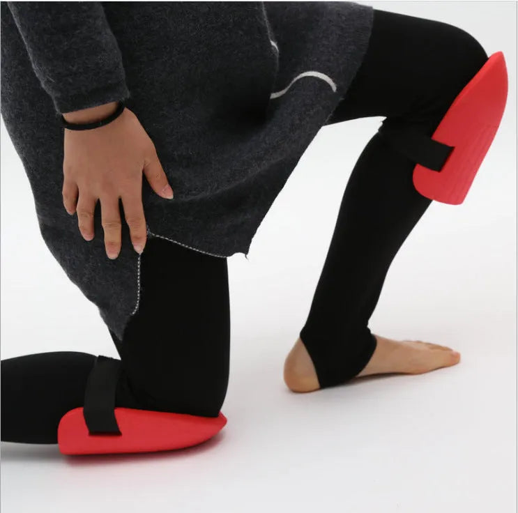 A pair of black EVA foam knee pads for gardening, showing their rectangular shape and soft texture.