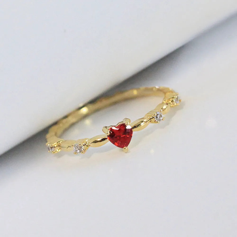 Gold electroplated copper ring with a peach heart charm and set zircon stone.
