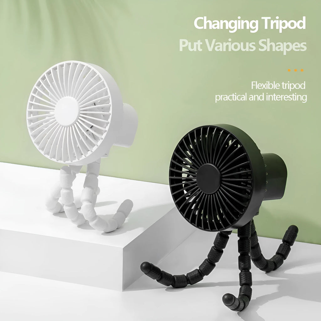 Compact USB desktop fan with flexible black tripod legs and a white fan head on a wooden desk.