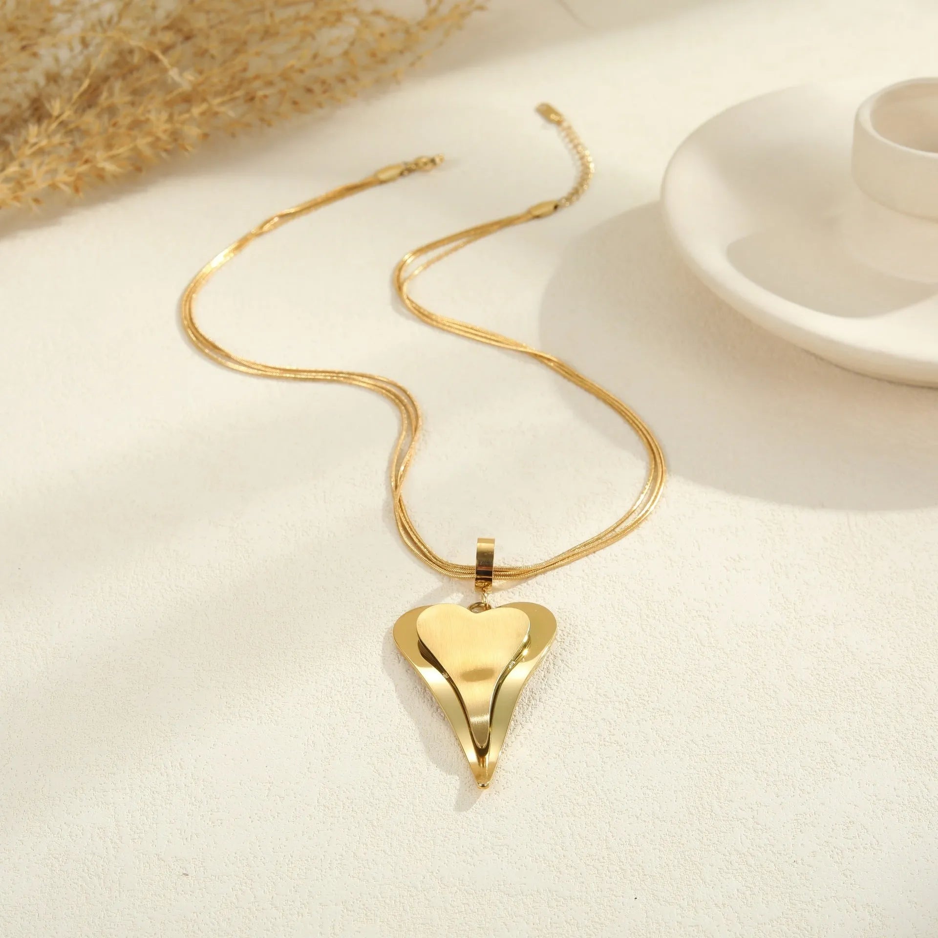 Geometric double heart and snake bones necklace in stainless steel with gold or steel finish on regular chain