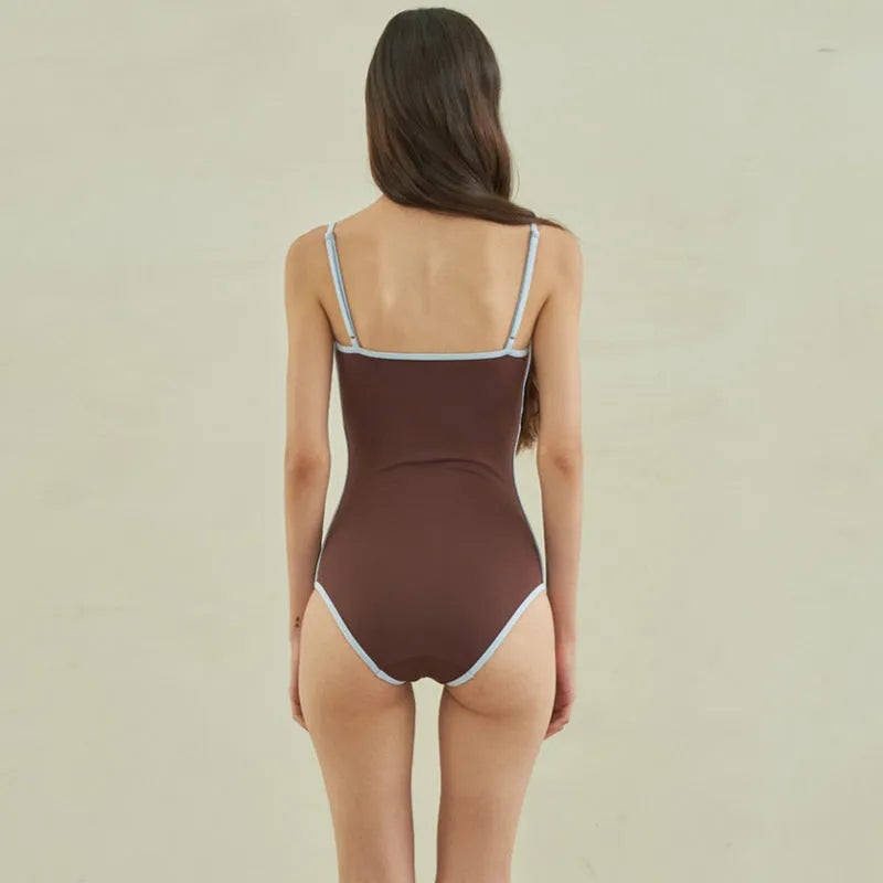 Brown triangle cut one-piece swimsuit for women on hanger showing front design