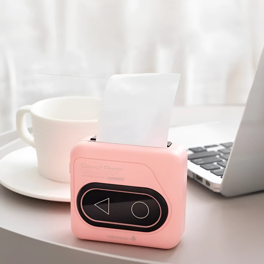 Compact Avocado Green Bluetooth mini thermal printer on a desk next to a mobile phone.