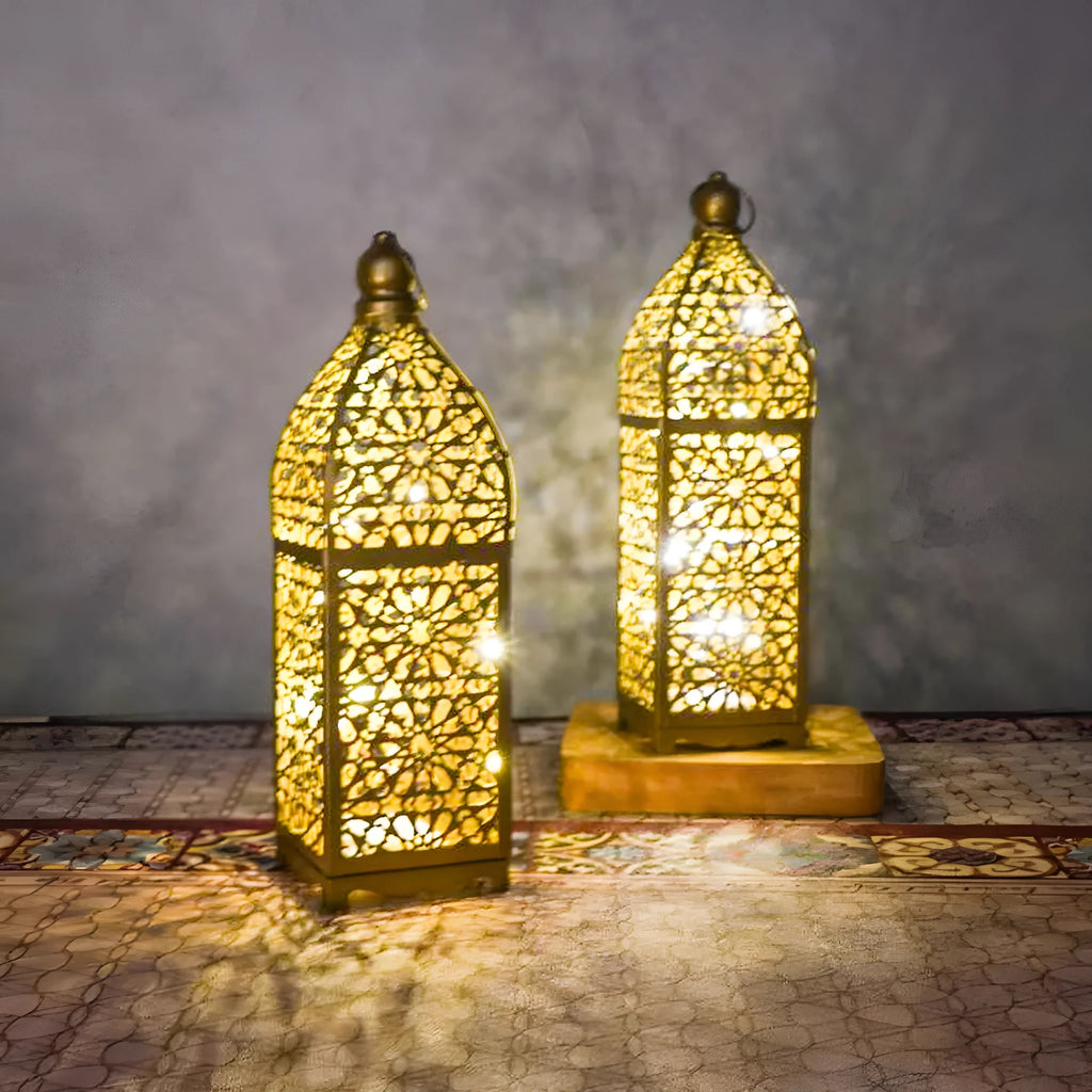 Gold L decorative iron barn lantern with hollow four-corner design on a tabletop