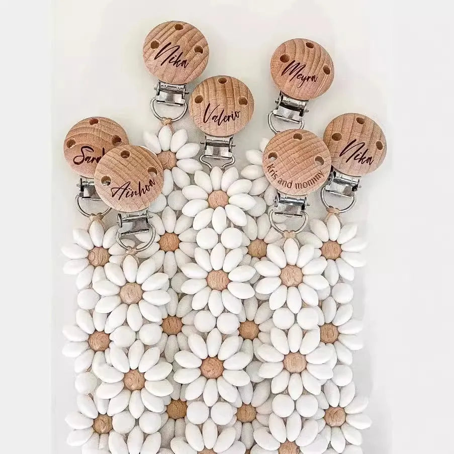 Silicone flower-shaped pacifier clip in Baby Pink with small beads and metal clip mechanism