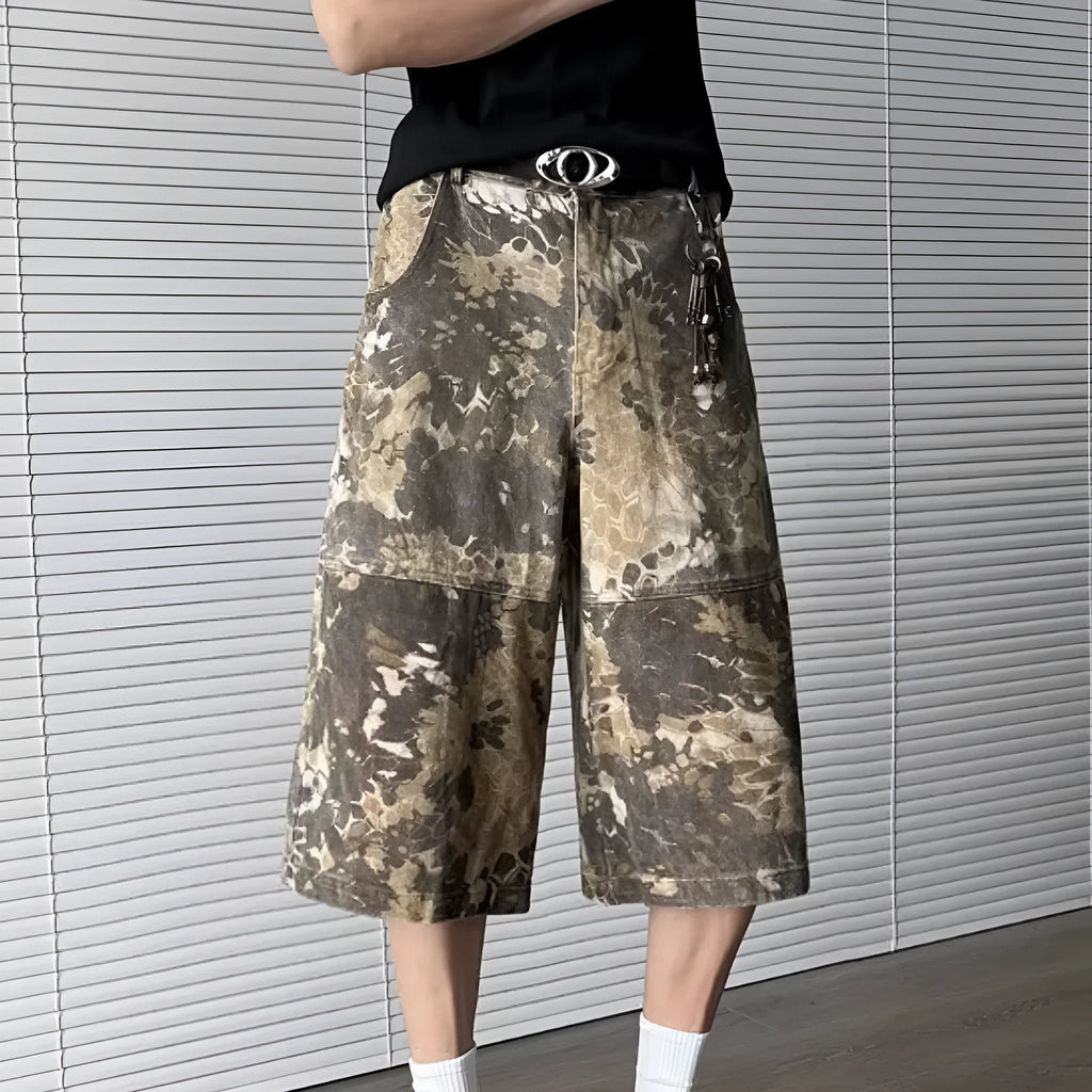 Yellow women's cropped jeans with a bold snake and camouflage pattern print on the legs.