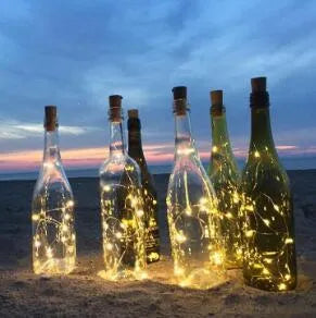Silver copper wire LED string lights wrapped around wine bottle with 20 white LEDs