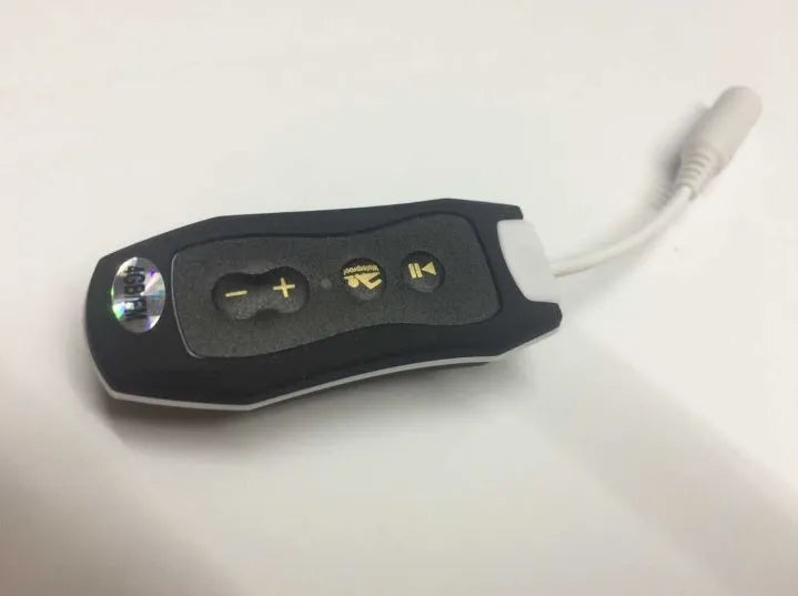 Compact black Bluetooth MP3 headset with USB cable, shown next to scale for size.