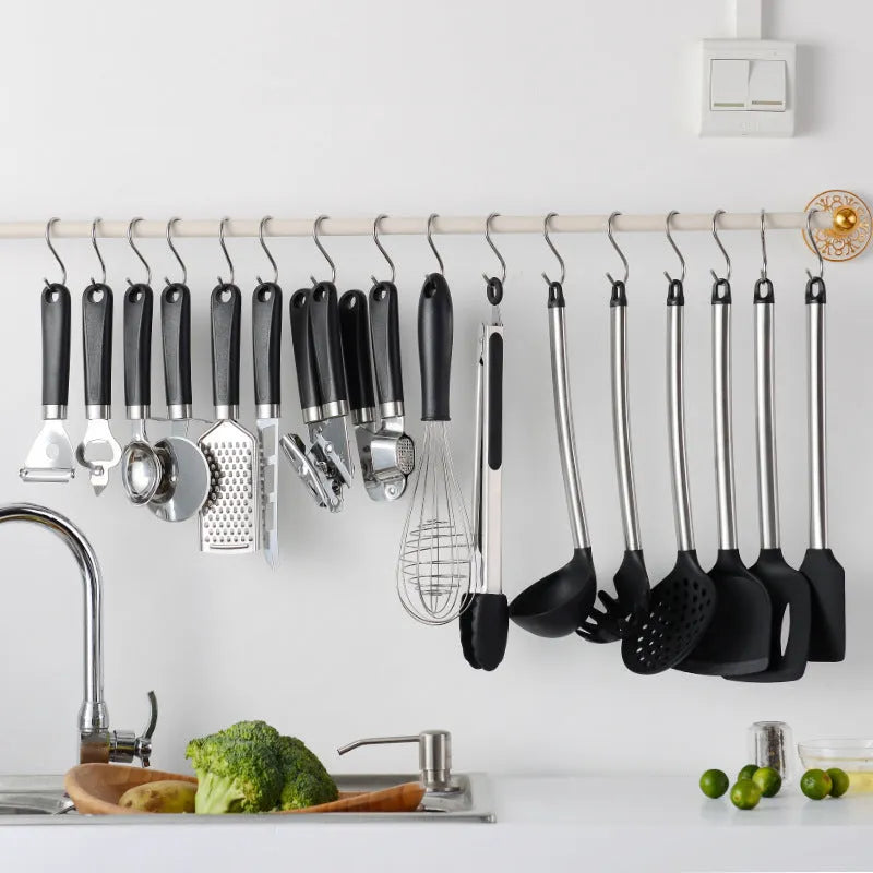 16-piece black silicone and stainless steel kitchen utensil set including spatulas and spoons.