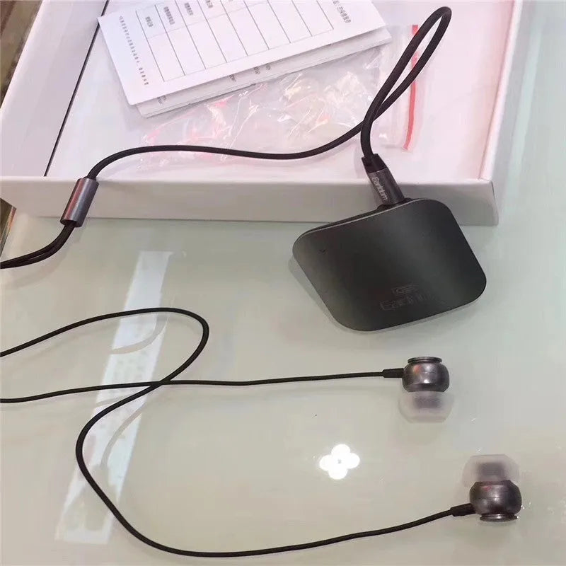 Black Bluetooth audio receiver unit for wireless headphones with lavalier earpiece
