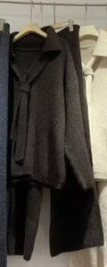 Women's dark grey knit top and trousers two-piece sweater suit set on a hanger