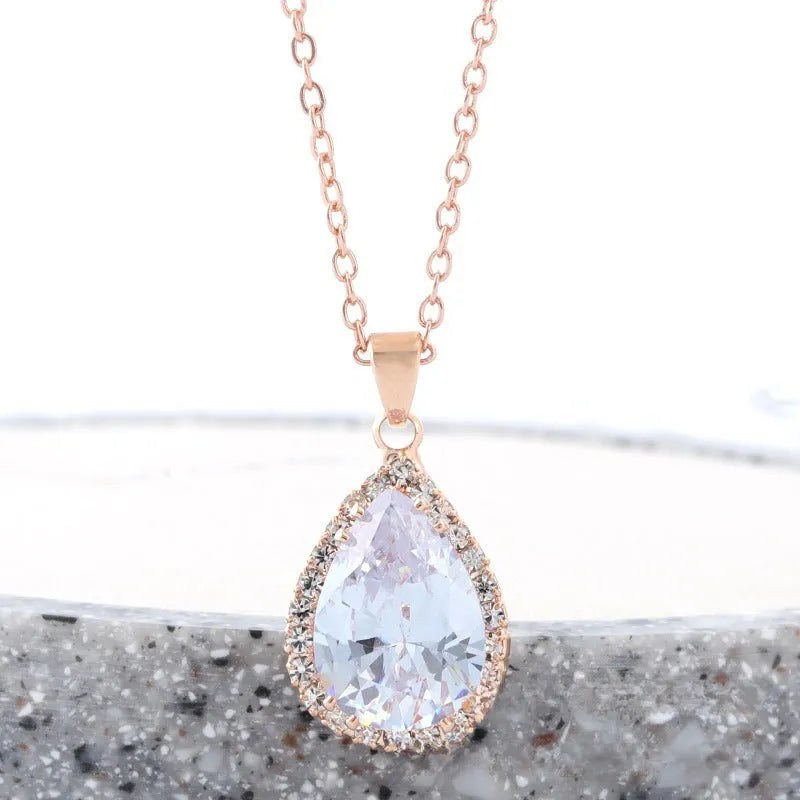 Women's geometric drop shape pendant necklace with rhinestone detail in pink electroplated finish.