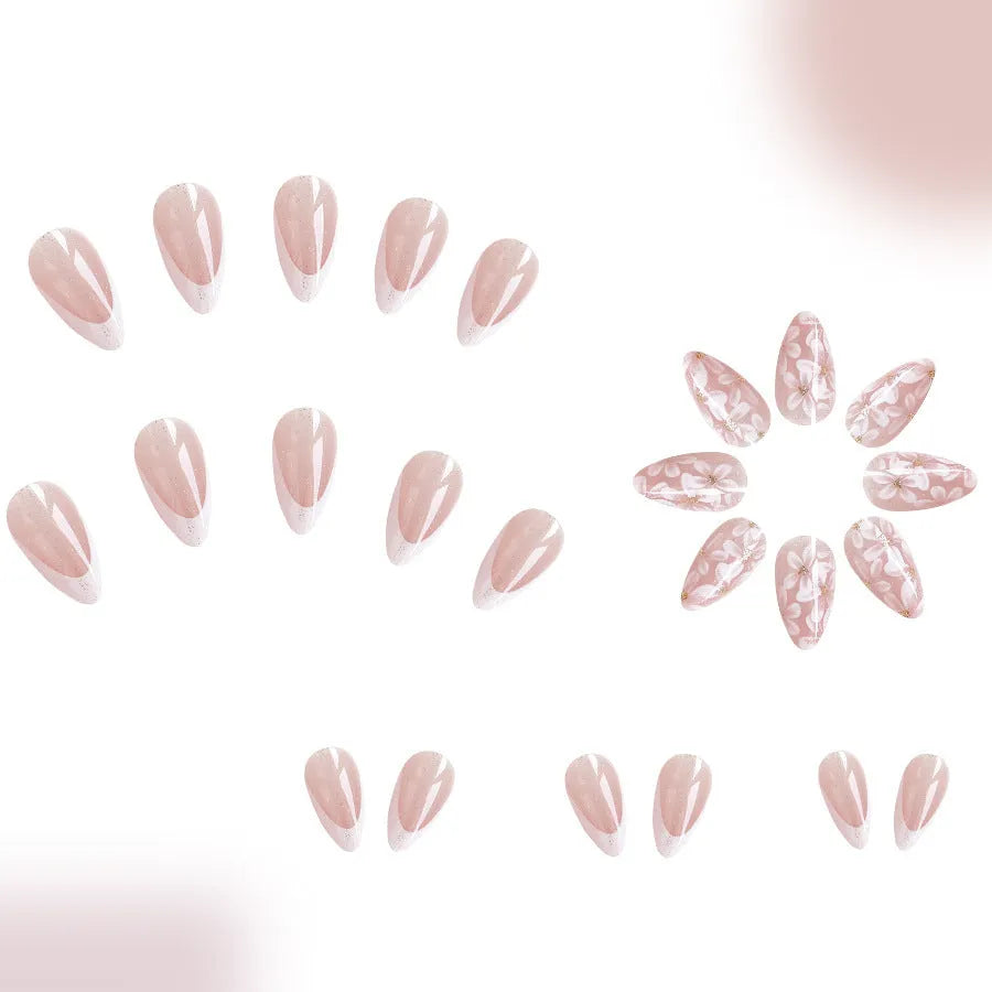 Short glossy almond-shaped false nails with glitter and flower French tip design, colour C625.