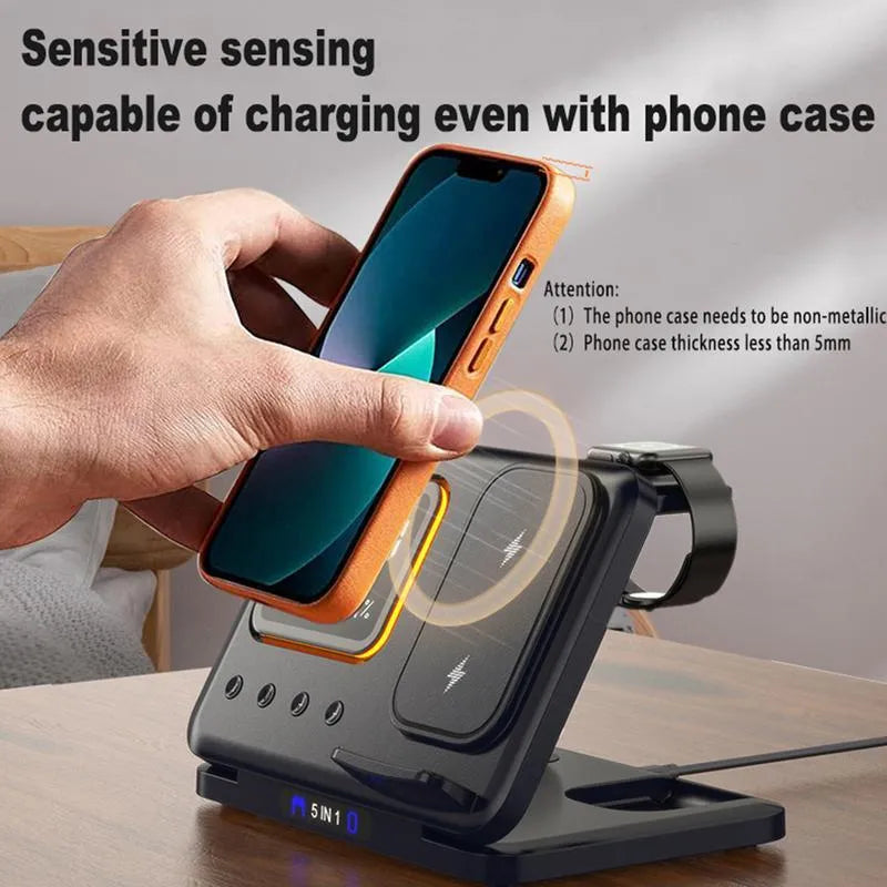 Black 5-in-1 wireless charging station showing phone charging alongside digital clock with temperature display