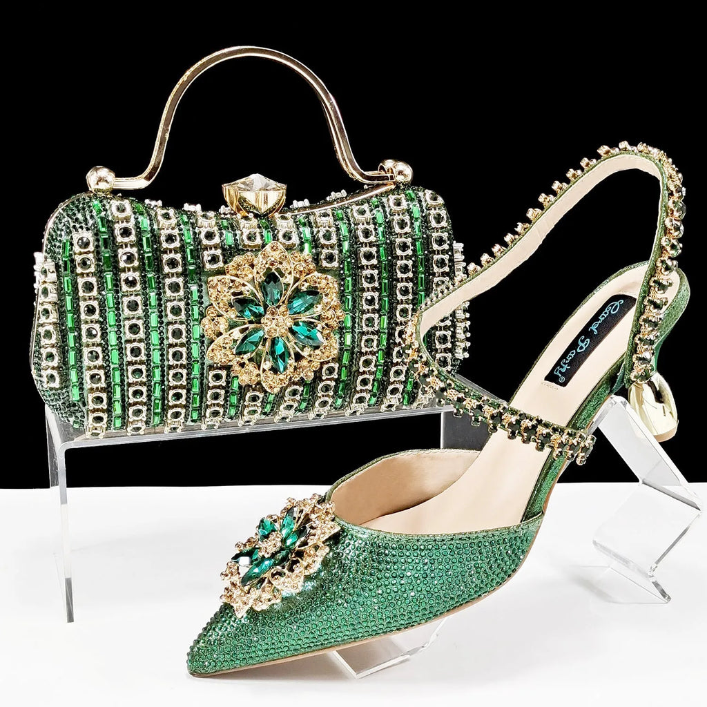 Women's black high heel ankle strap sandal with rhinestone flower and matching clutch bag.