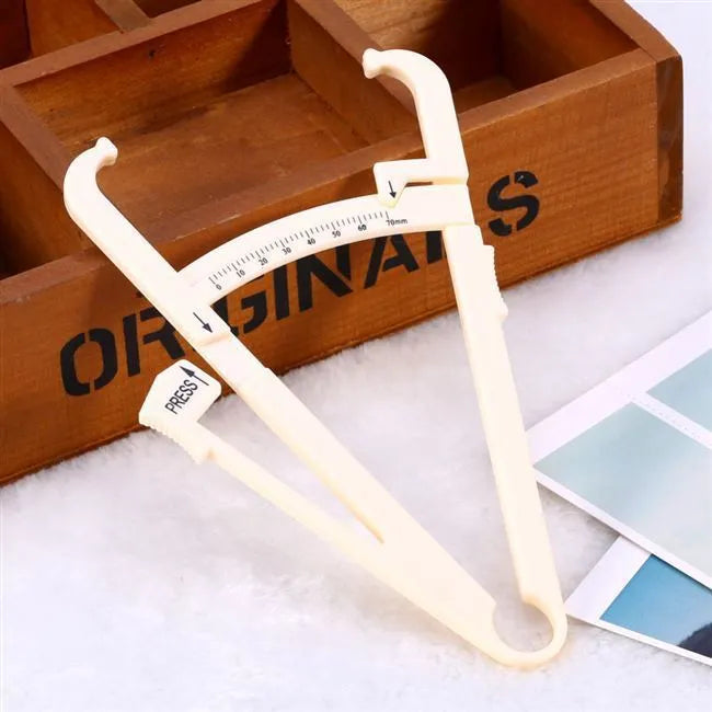 Clear acrylic body fat caliper showing measurement scale up to 200mm with sebum clamp design