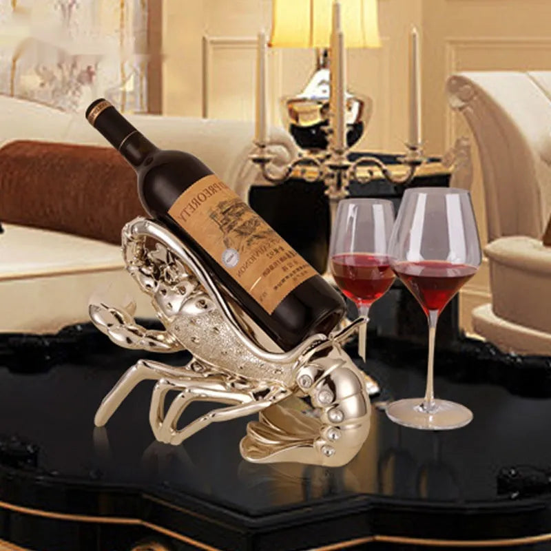 Metallic rose gold lobster-shaped resin ornament holding a wine bottle.
