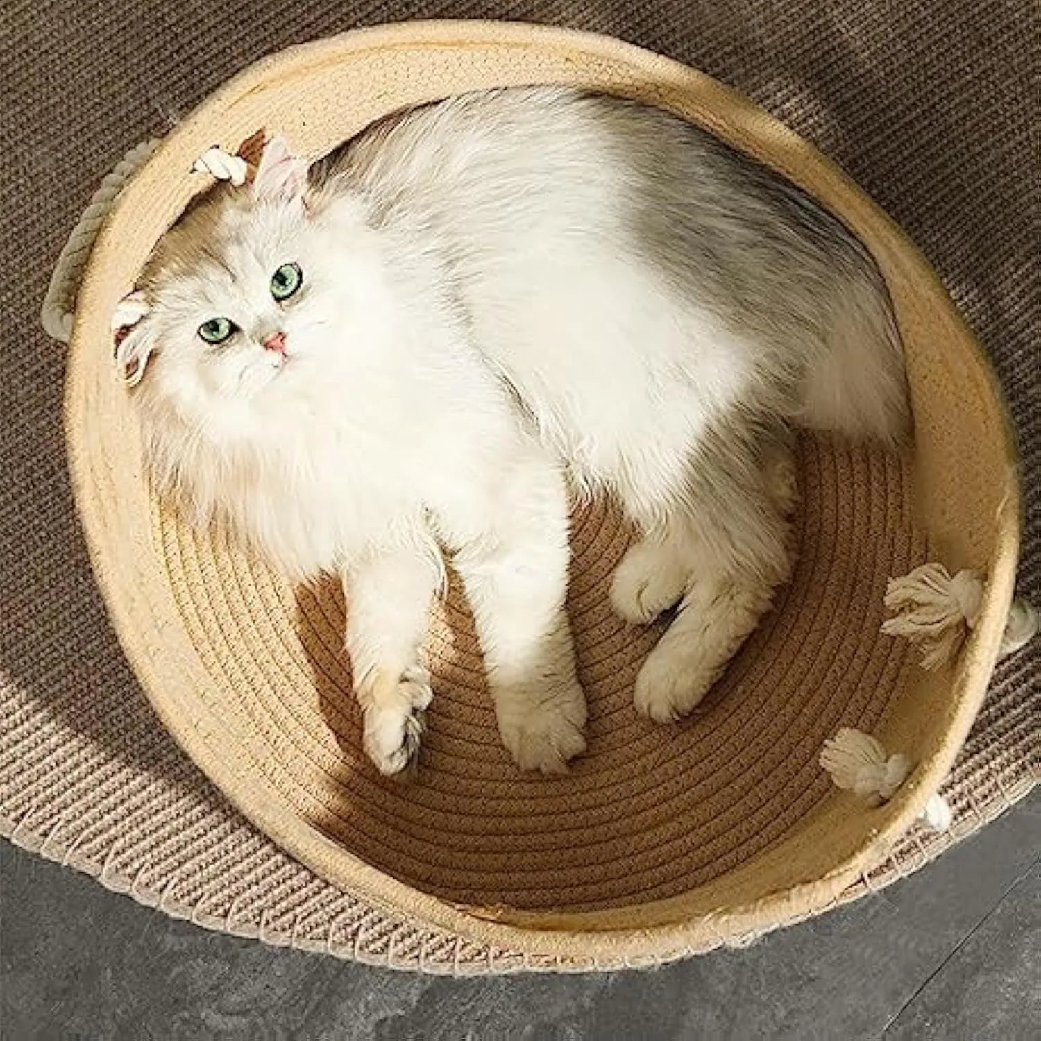 Wicker-style cat bed basket with a corrugated scratching board inside.