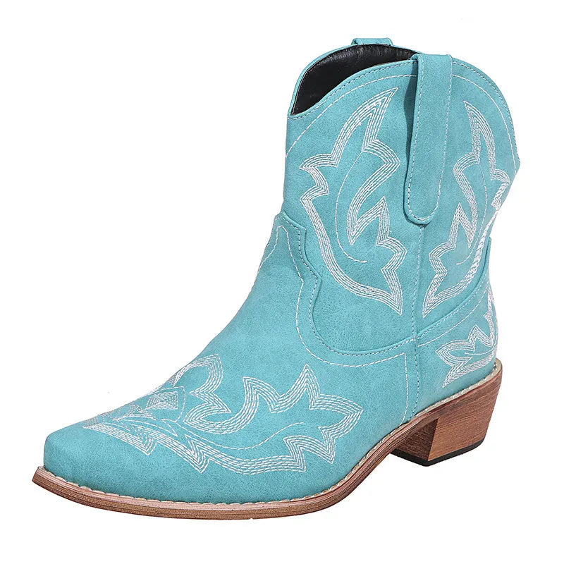 Women's blue cowboy boots with wedge heel, pointed toe, and embroidery details on low canister.