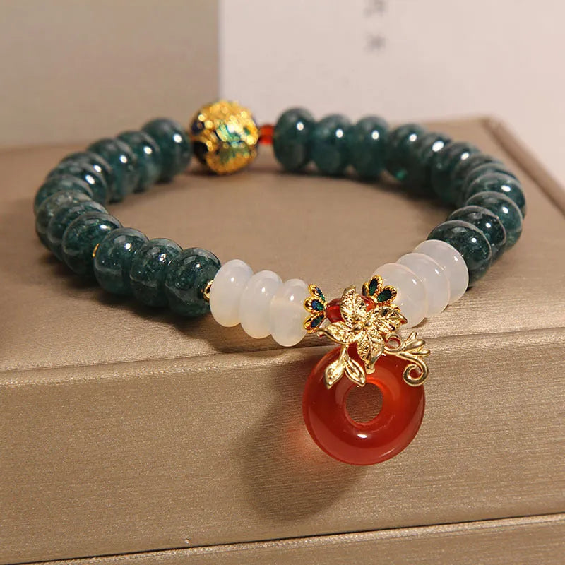 Blue water jade and red agate bracelet with crystal beads and a peace buckle closure