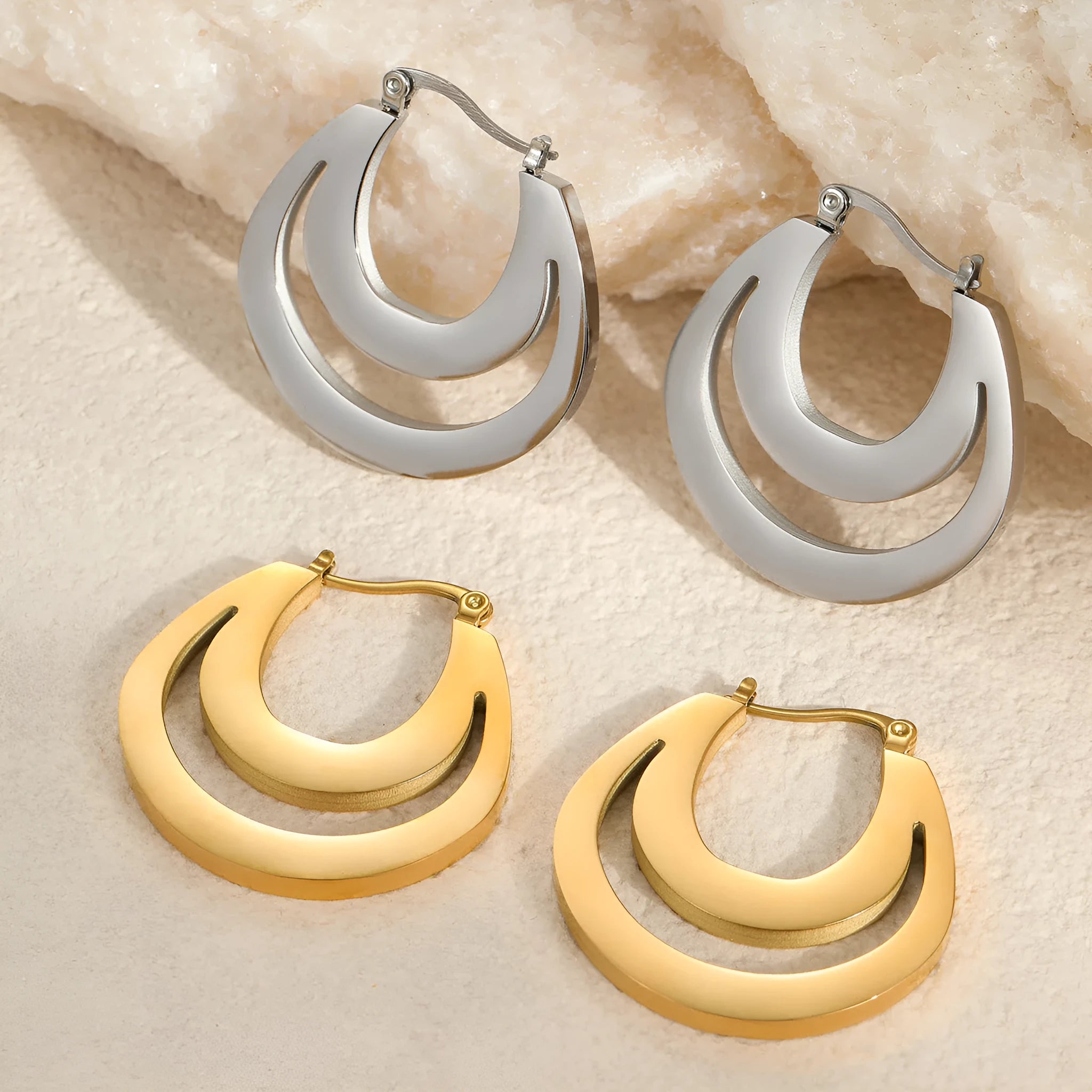Geometric French earrings with gold plating and round ring elements on stainless steel