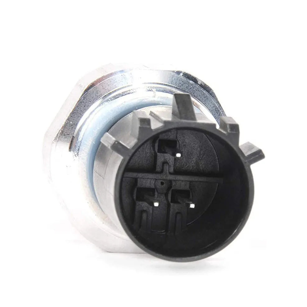 Silver metal automobile fuel pressure sensor on a plain background