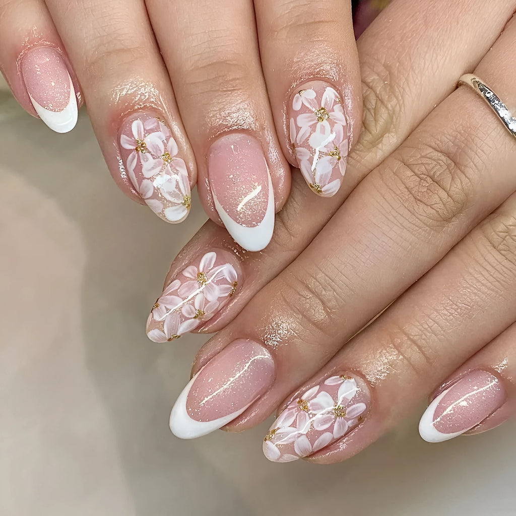 Short glossy almond-shaped false nails with glitter and flower French tip design, colour C625.