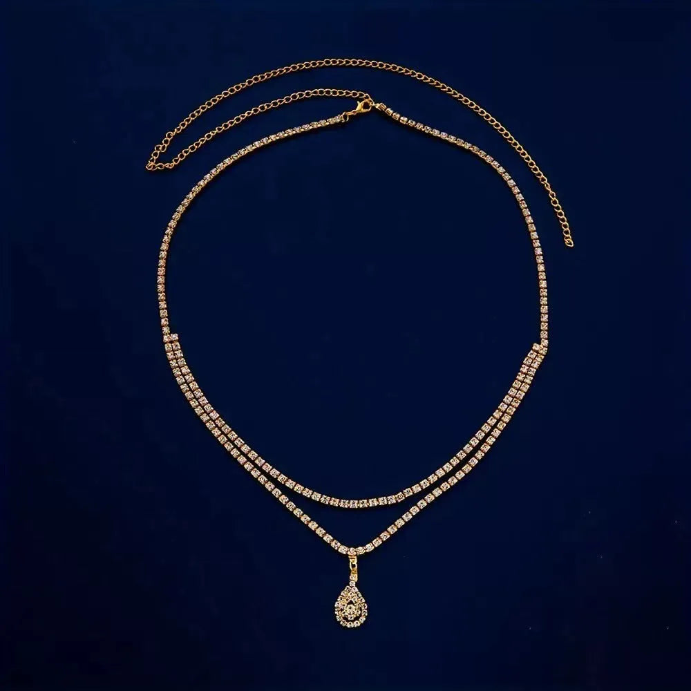 Women's gold rhinestone waist chain with water drop pendant and tassel details